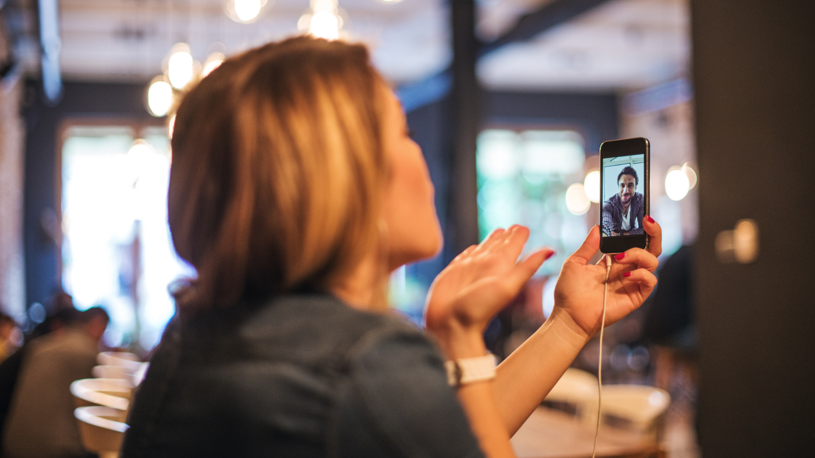 Stay connected via video chat, student blowing kiss